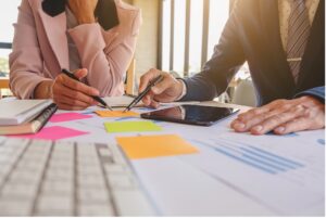 Two company owners working through figures on a business plan at a table