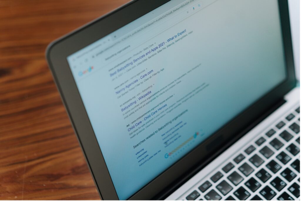 A laptop displaying a Google Search results page.