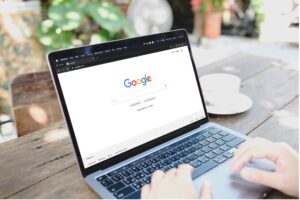 A laptop on a table showing the Google search homepage, as a buyer starts researching suppliers