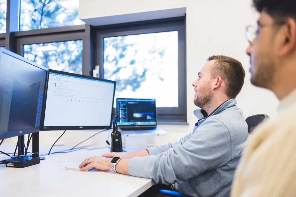 Josh and Sajan working around Josh's desk