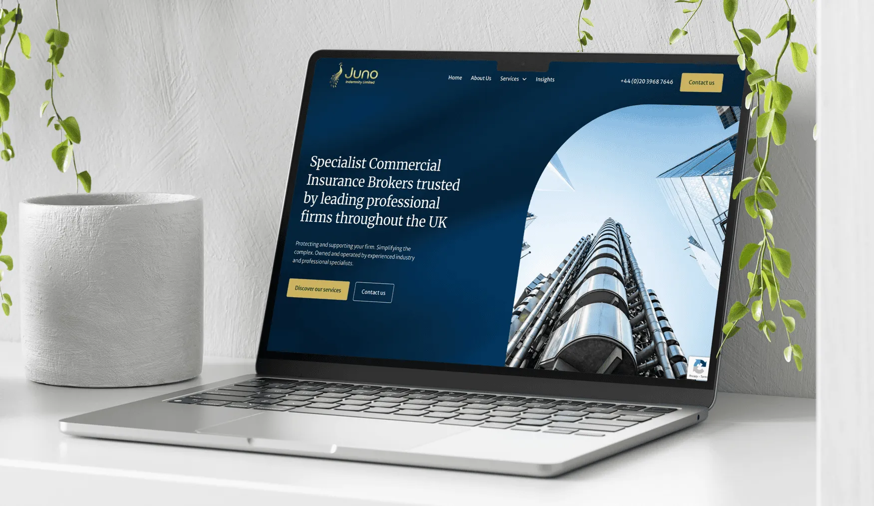 Juno Indemnity homepage mockup on a laptop device