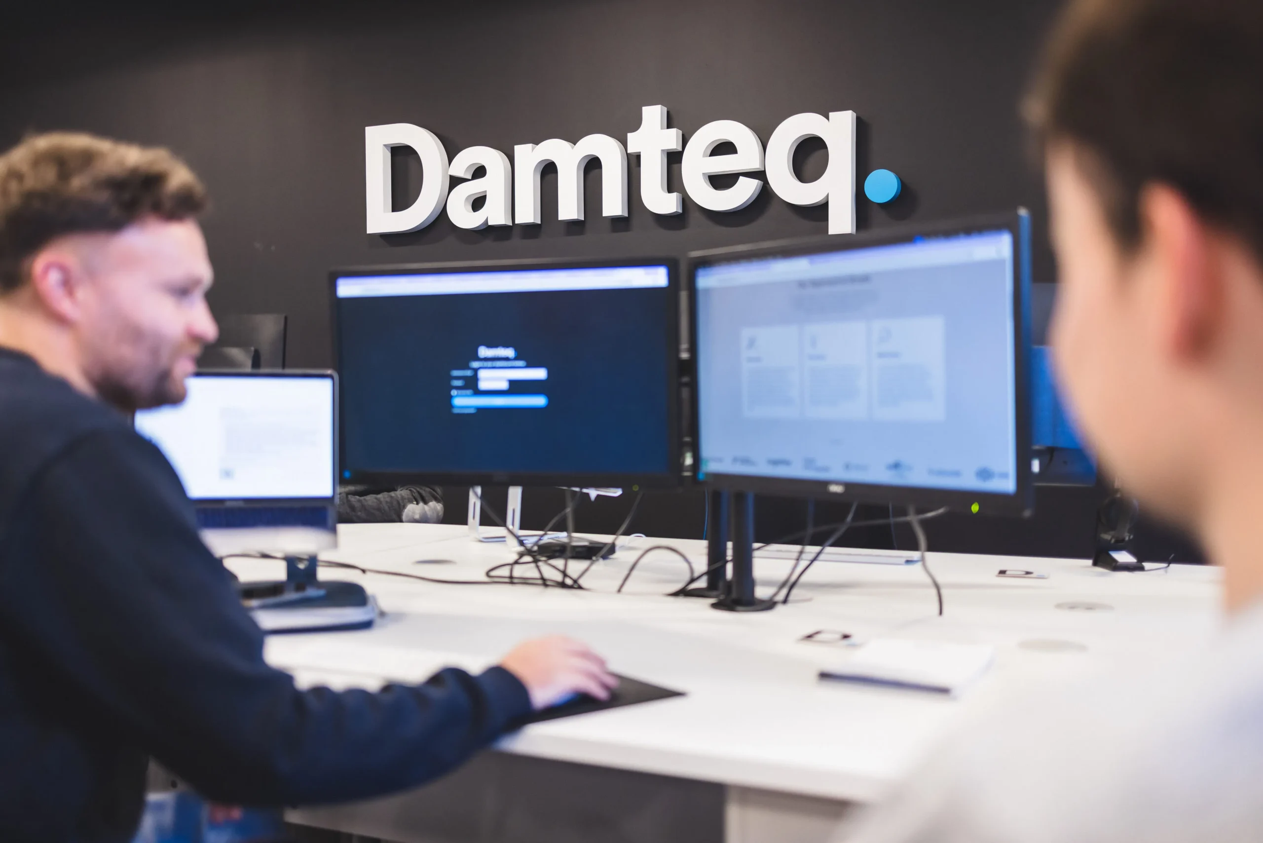 Damteq's PPC team at their desks.