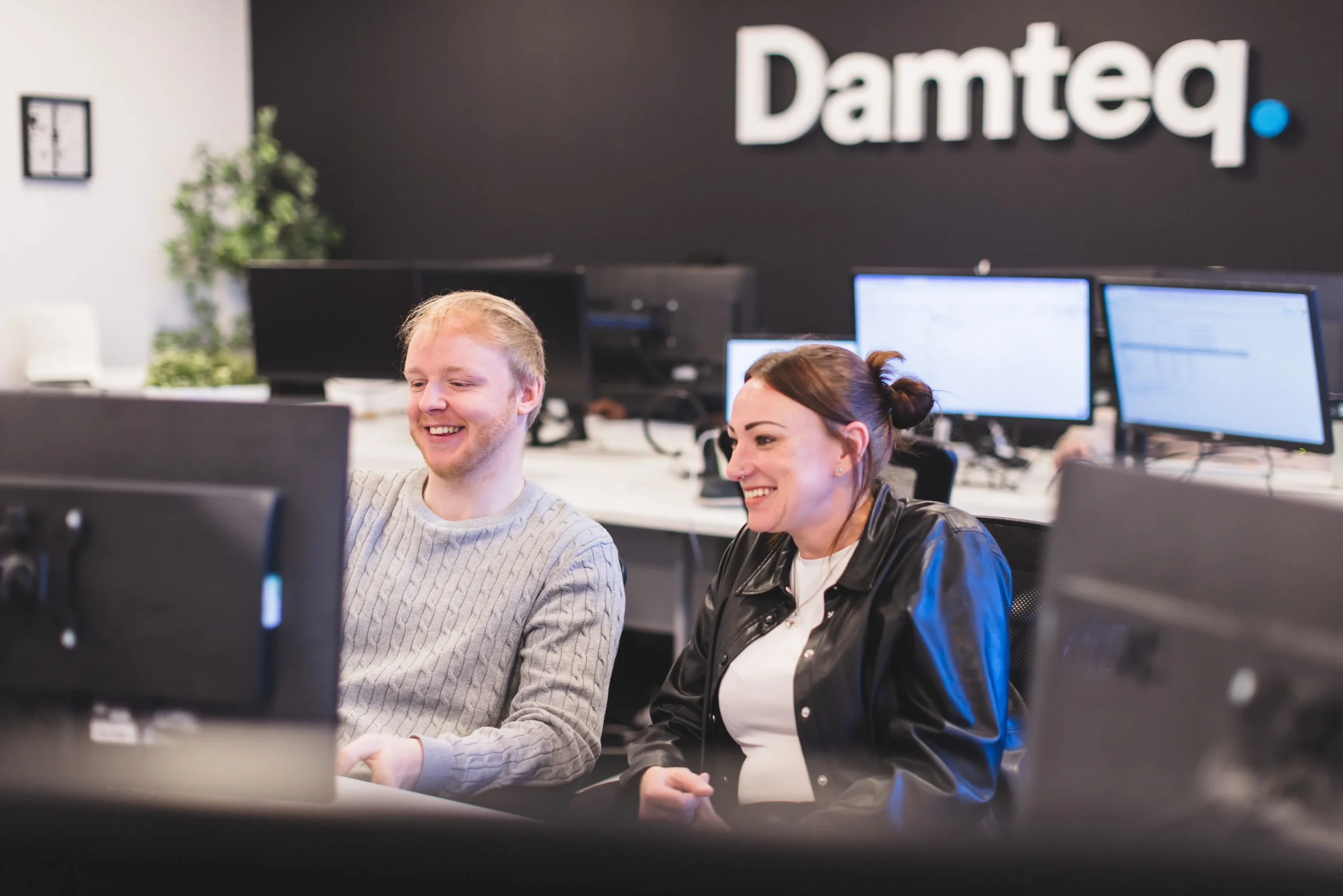 Patryk and Gemma, collaborating at a desk in front of a computer monitor