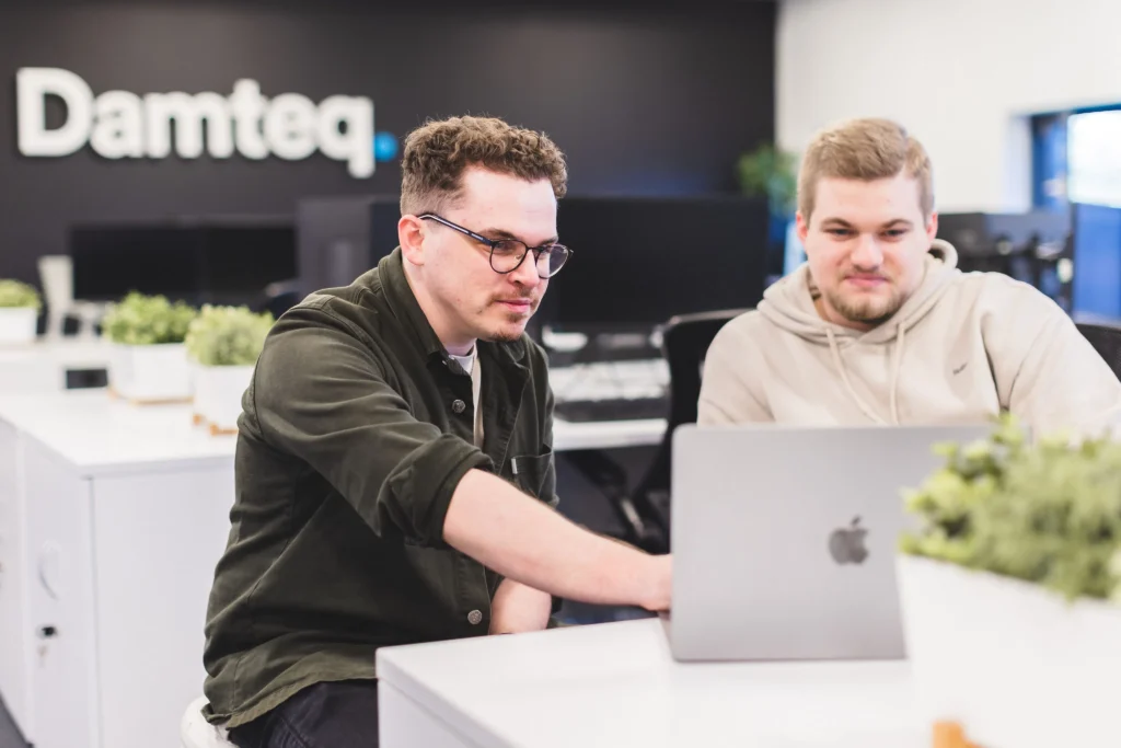 Robin and Jordan working around a single laptop