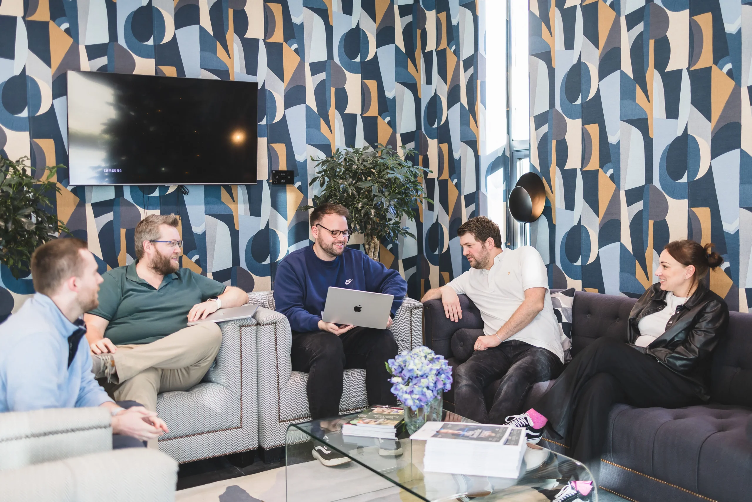 The Damteq team collaborating on sofas.