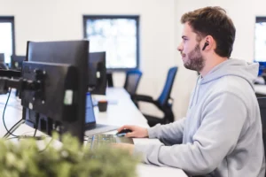 Tom sat at his desk working